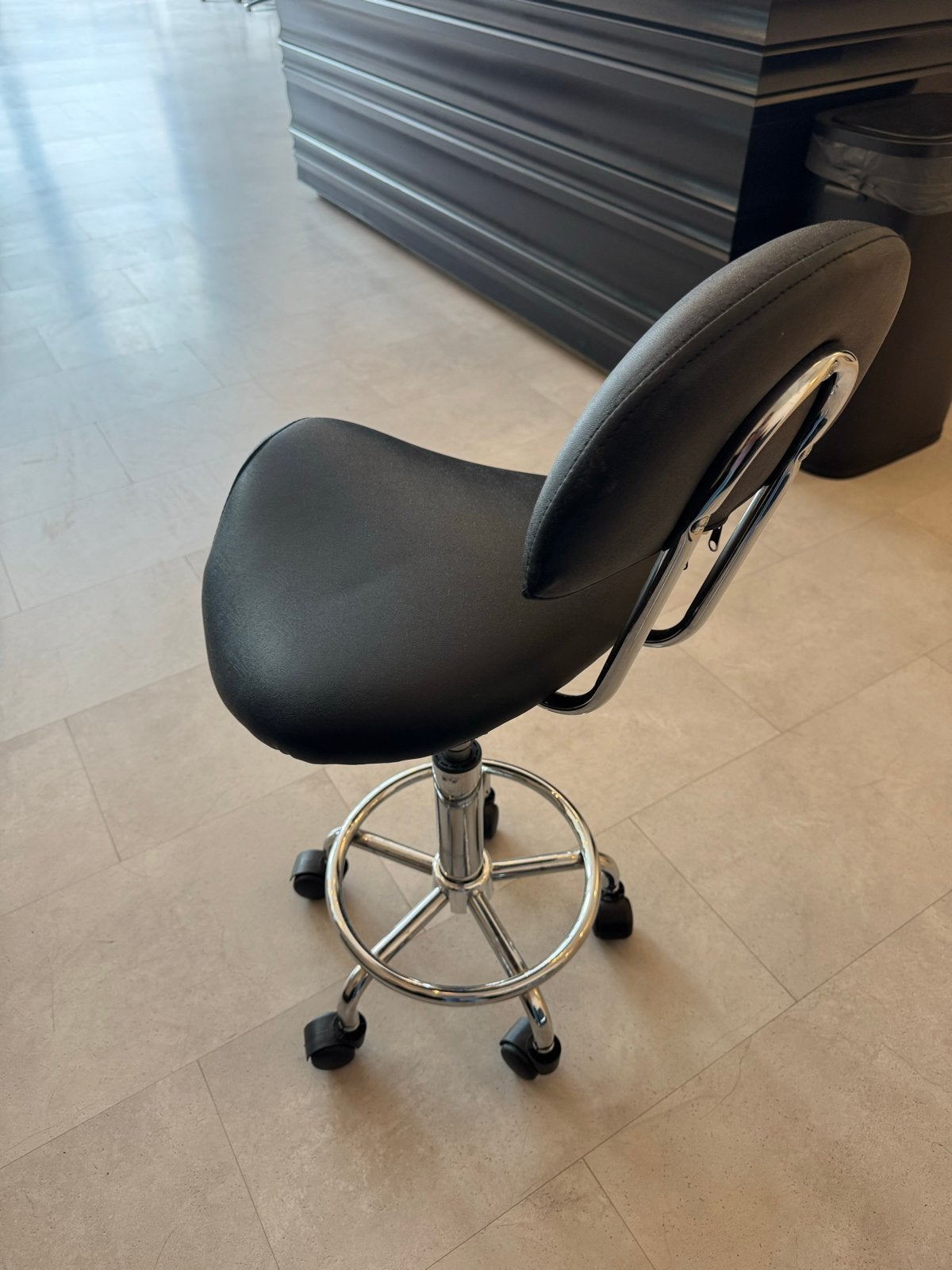 Zwarte ergonomische zadelkruk met rugleuning