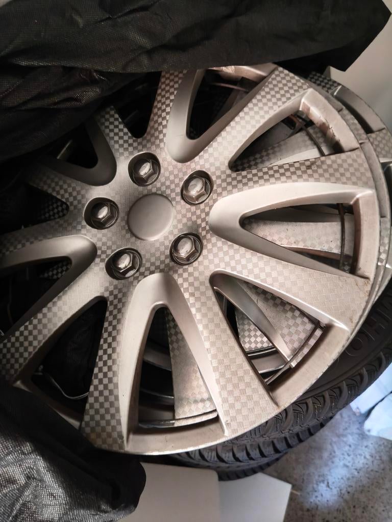 Winterbanden Opel Corsa/Meriva met wieldoppen, Ophalen