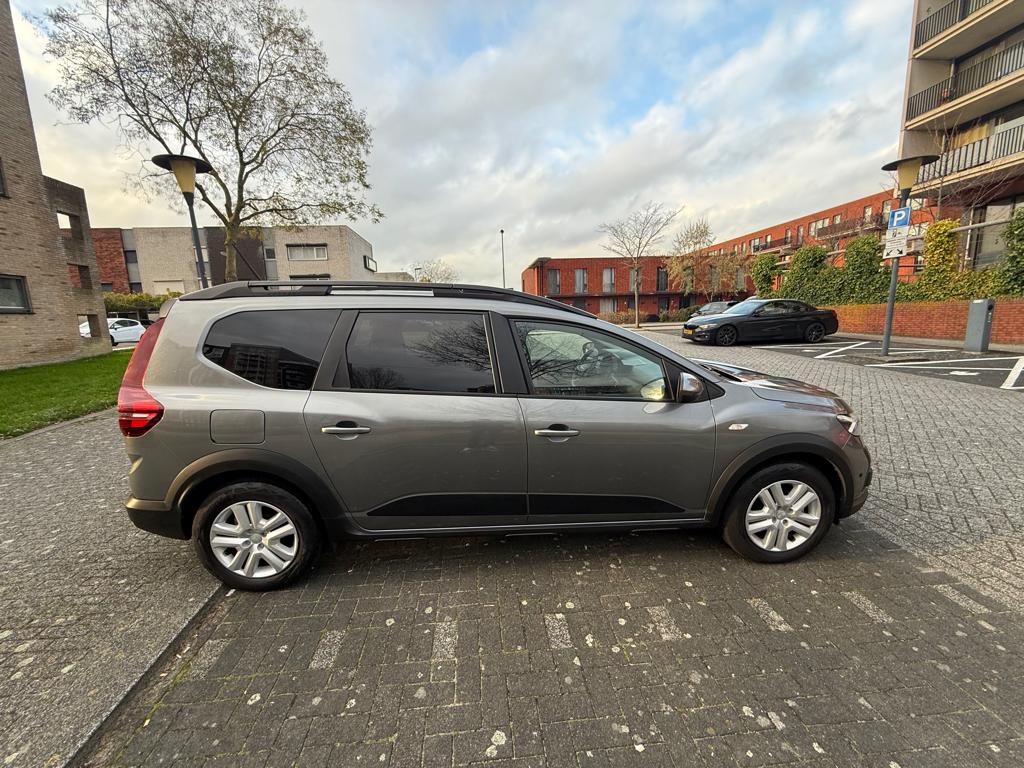 Dacia Jogger Hybrid 140pk Aut 7pl 2023 Grijs, Auto's, 750 kg, 4 cilinders, 7 stoelen, Origineel Nederlands