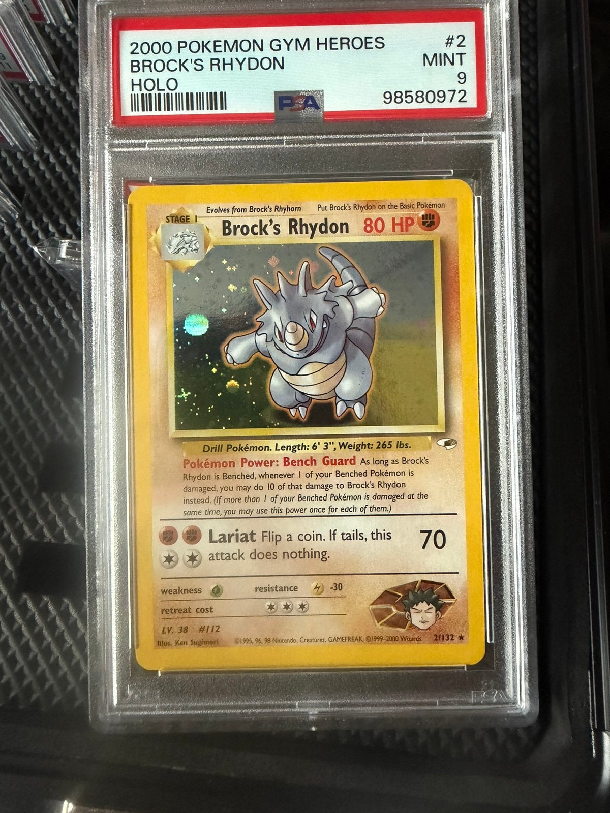 Brock's Rhydon Pokémon kaart PSA 9 Mint met swirl, Ophalen of Verzenden, Zo goed als nieuw, Losse kaart, Foil