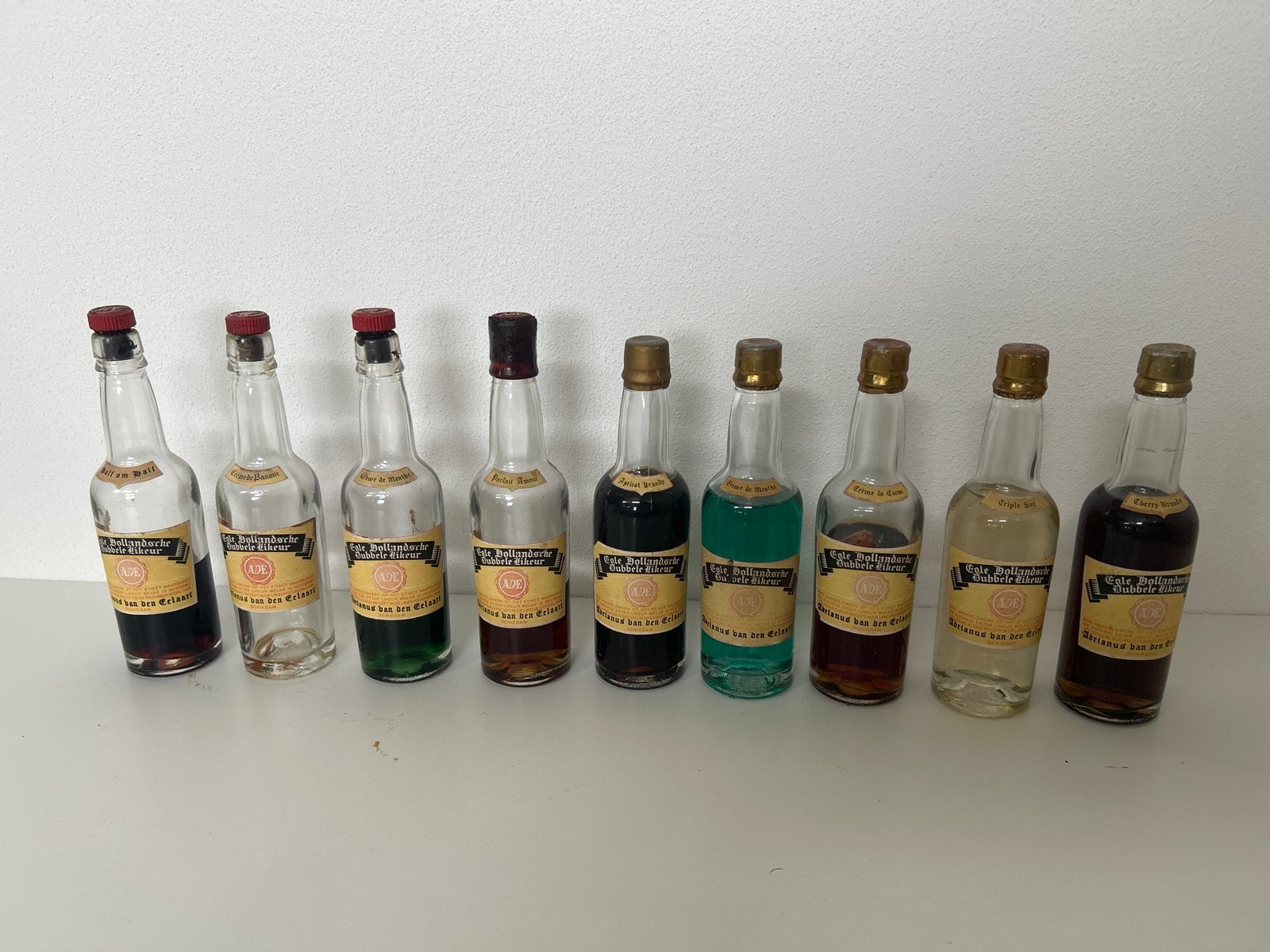 9x antieke miniatuur likeurflesjes van ADE, Ophalen of Verzenden