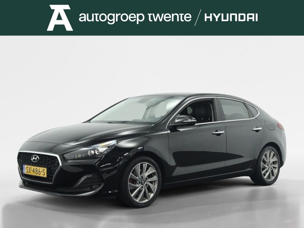 Hyundai i30 Fastback 1.0 T-GDI Premium | Trekhaak | Navigati, Auto's, Keurmerk '100% Onderhouden', 12 maanden, Gebruikt, Leder en Stof