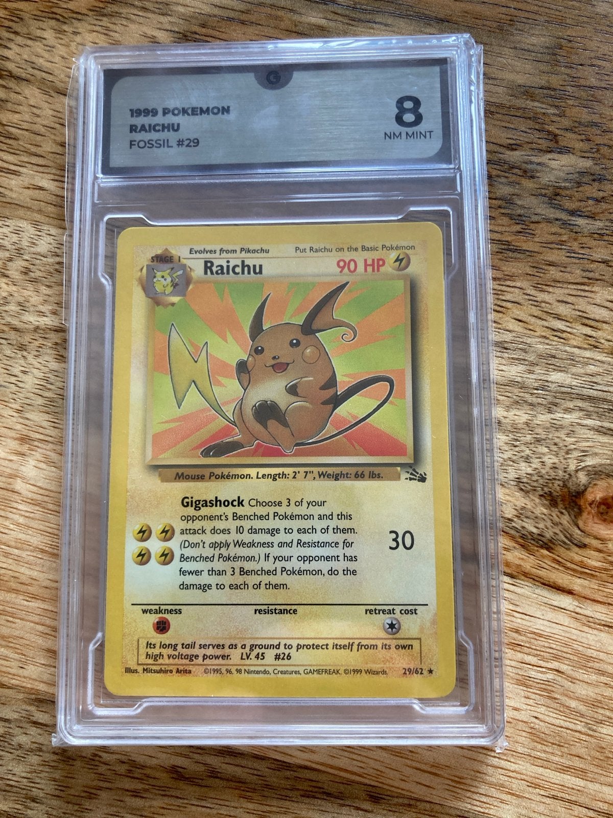 1999 Pokemon Raichu Fossil #29 Global Grading 8 NM MINT, Ophalen of Verzenden, Zo goed als nieuw, Losse kaart