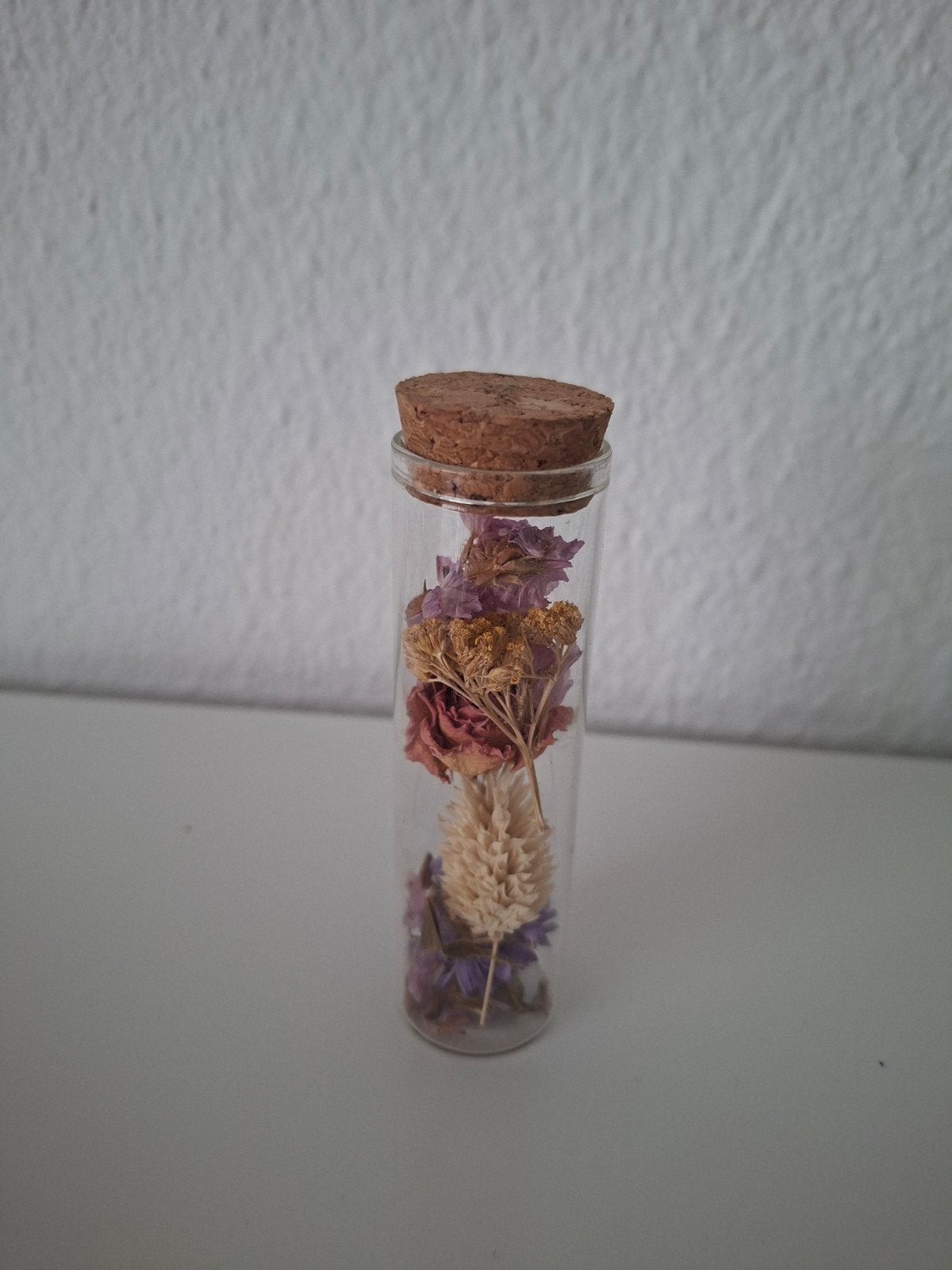 Glazen buisje met droogbloemen, Ophalen
