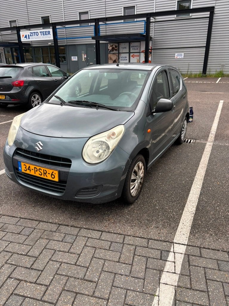 Suzuki Alto 1.0 2011 Grijs, Auto's, Voorwielaandrijving, Stof, 4 stoelen, Origineel Nederlands