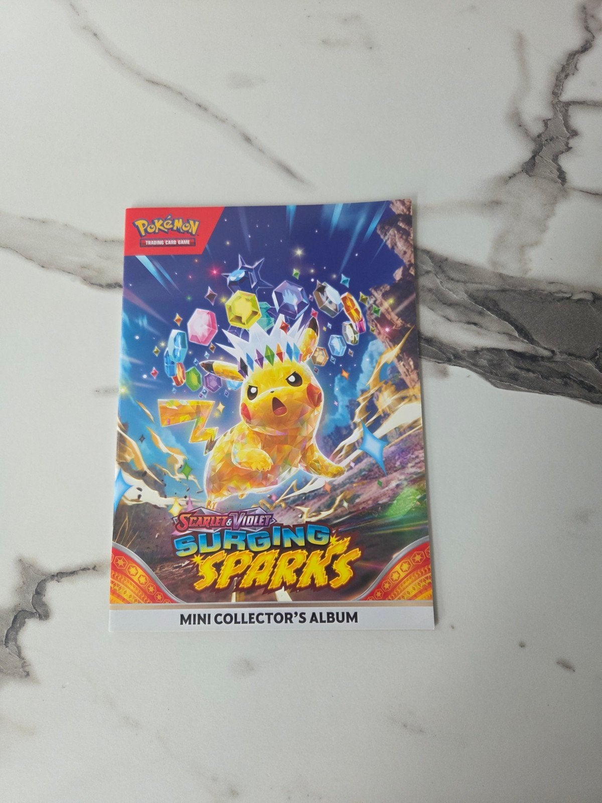 Pokémon kaarten mini collector's album Surging Sparks, Ophalen of Verzenden, Zo goed als nieuw, Boek of Catalogus