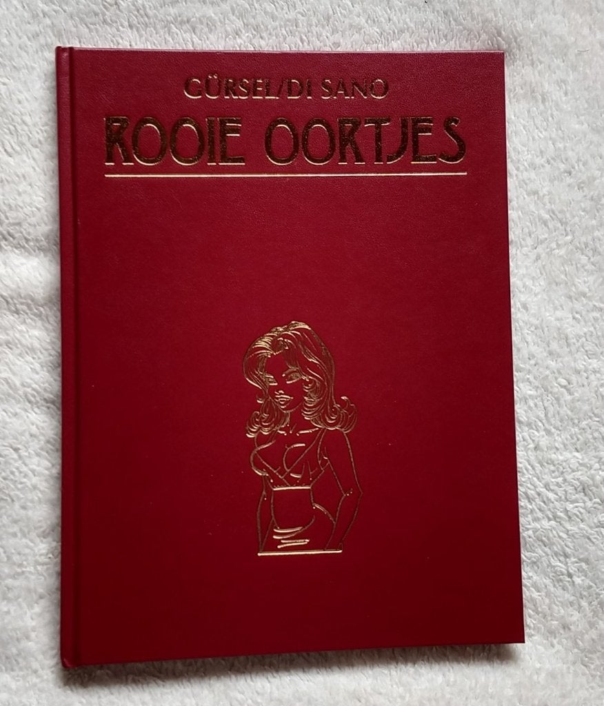 rooie oortjes hardcover, Dixon Gürsel Di Sano, volgnr 20, Boeken, Stripboeken, Eén stripboek, Ophalen of Verzenden, Zo goed als nieuw