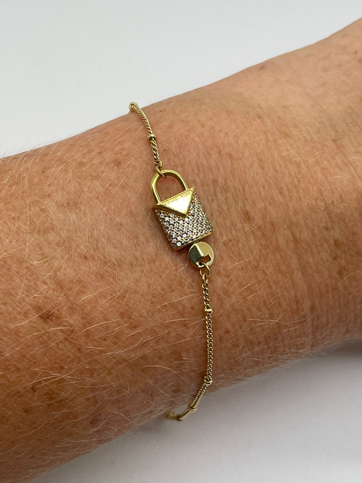 F419 Prachtige zilveren Michael Kors armband goudkleur, Ophalen of Verzenden, X, Goud, X