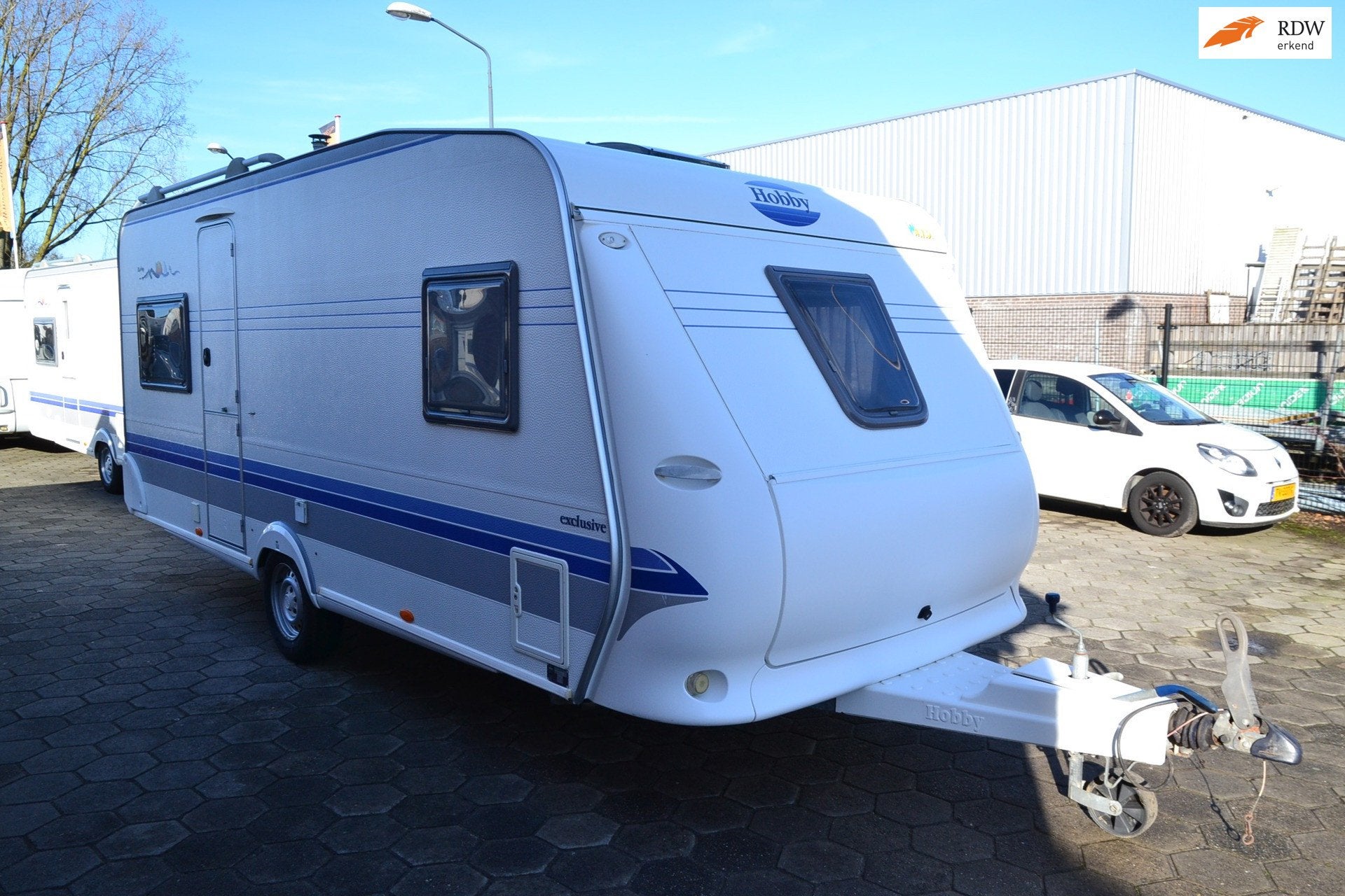 Hobby 495 B Exclusive - Frans bed - Wc+Douche - Voortent - G, Caravans en Kamperen, Vast bed, Schokbreker, Bedrijf, 4 tot 5 meter