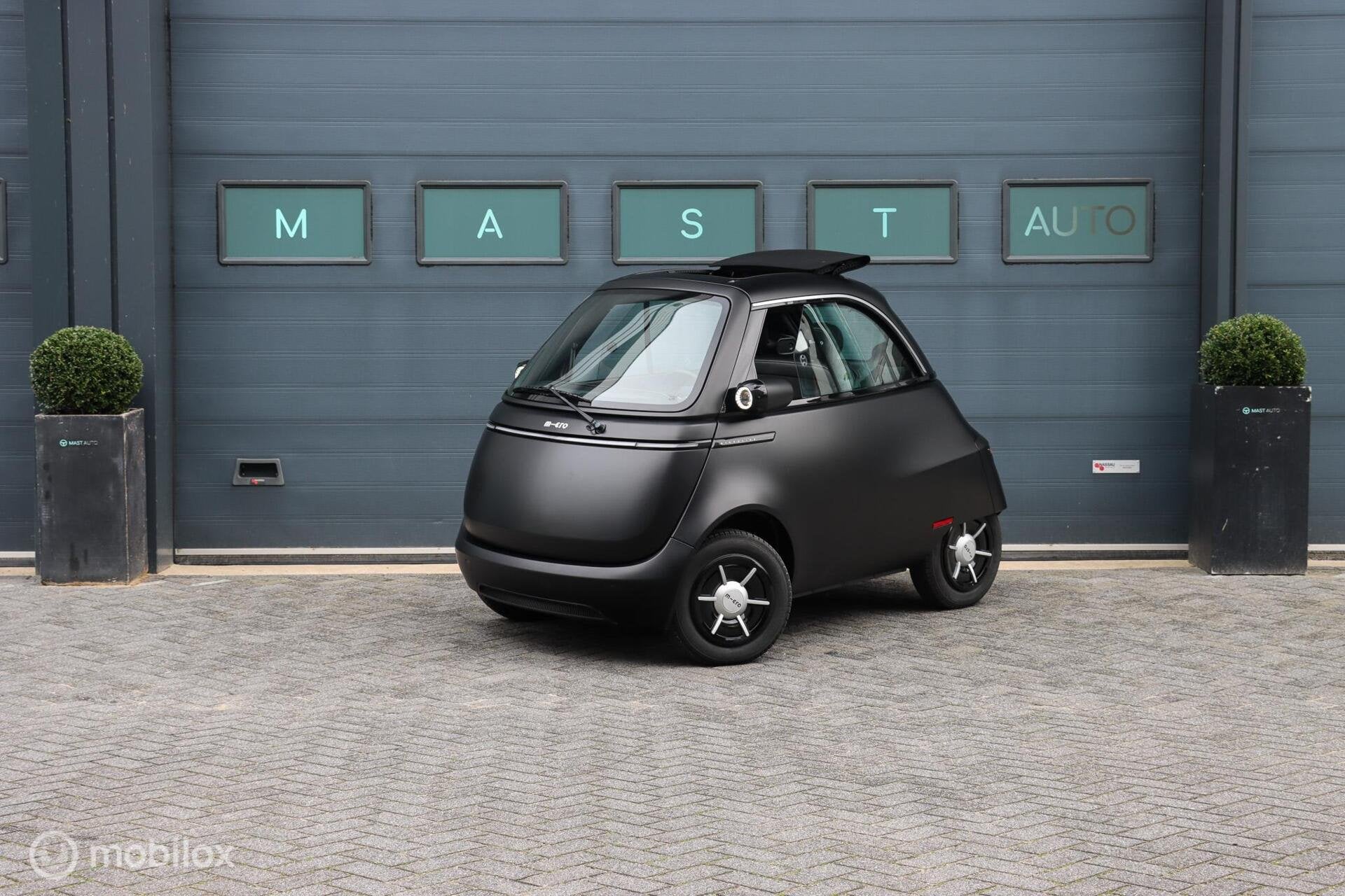 Microlino Competizione 10.5 kWh L7 177 Km. 90 KM/U|BTW|FOLDI, Auto's, Dealer onderhouden, Gebruikt, Zwart, Overige carrosserieën