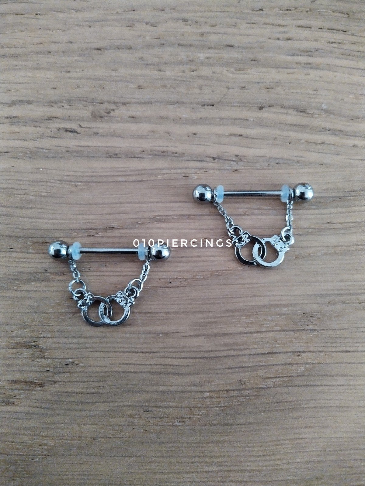 Nieuwe tepelpiercing. Handboeien., Ophalen of Verzenden, Zo goed als nieuw, Staal, Oor- of Traguspiercing