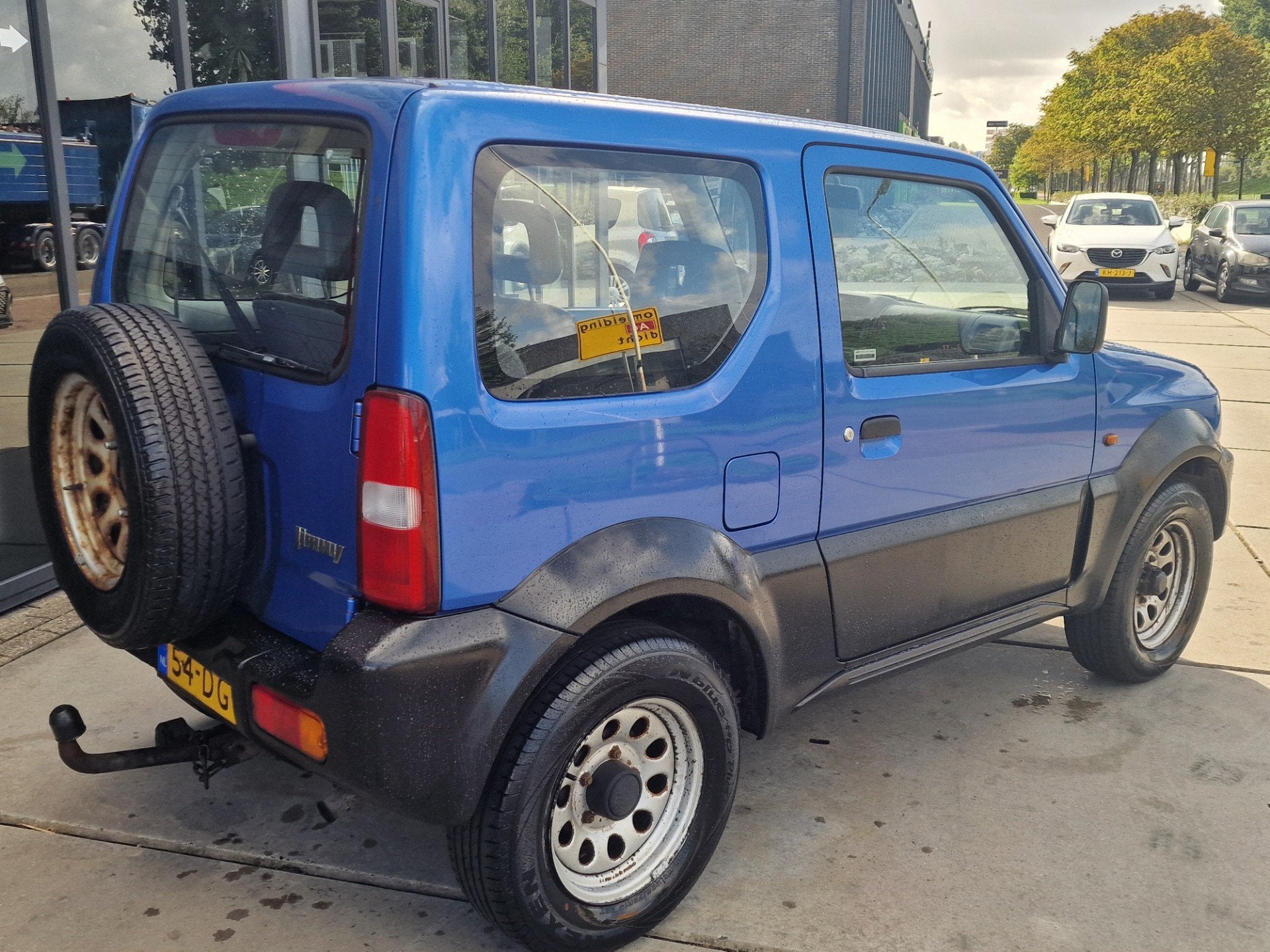 Suzuki Jimny 1.3 JX 4WD Trekhaak, Auto's, Euro 2, Zwart, 4 cilinders, Leder en Stof