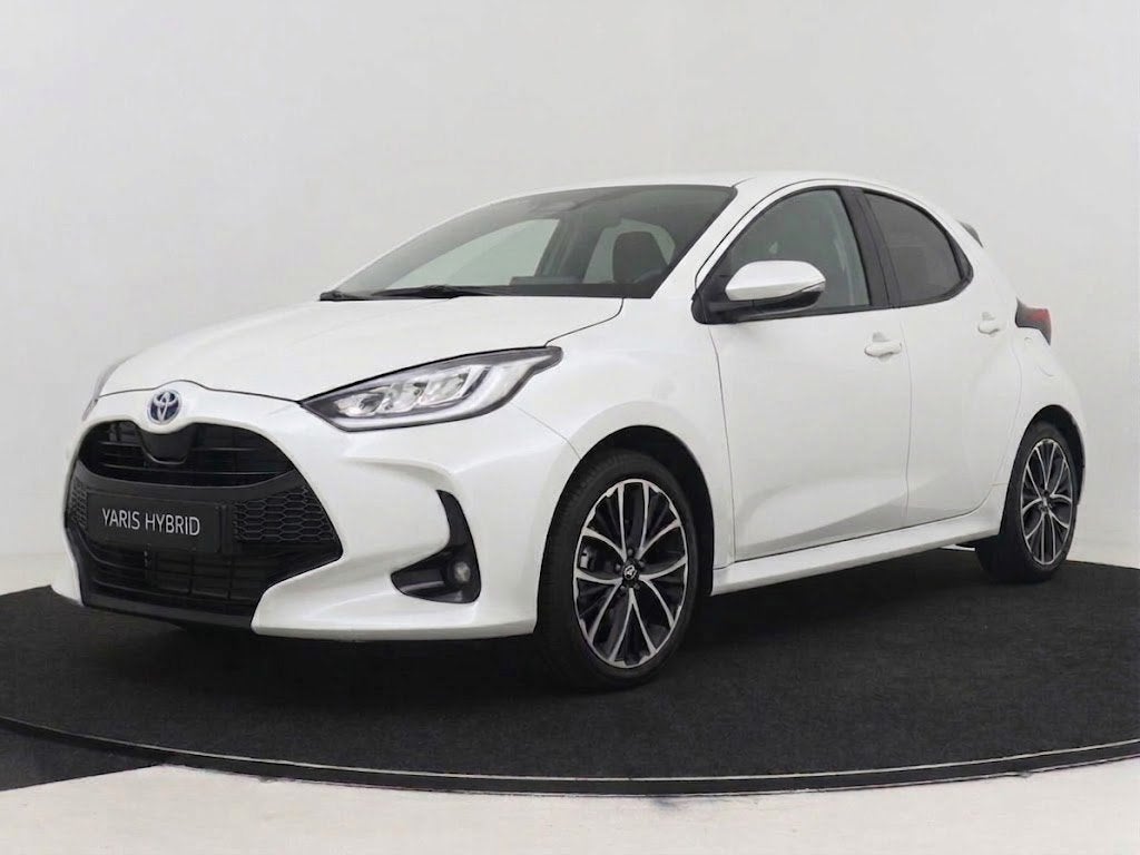 Toyota Yaris 1.5 Hybrid 115 Dynamic I NIEUW & DIRECT LEVERBA, Auto's, Wit, Nieuw, Hybride Elektrisch/Benzine, 3 cilinders