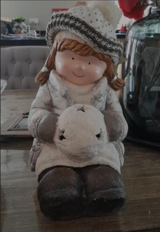 kerstmeisje met lampje, Ophalen