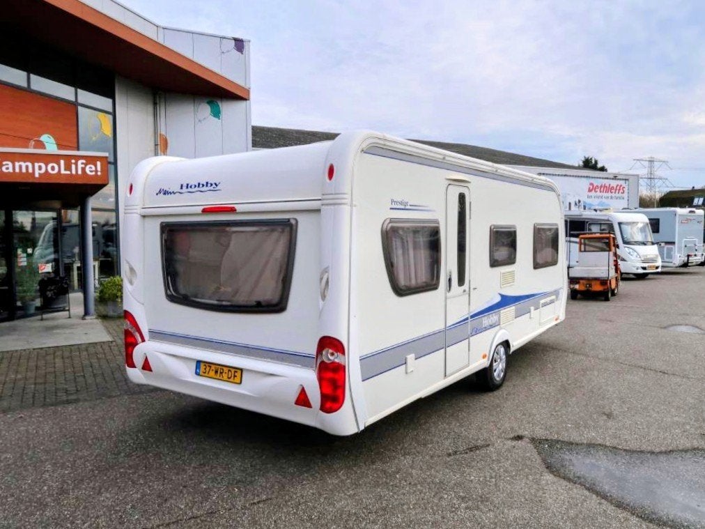 Hobby Prestige 560 UL (met mover, airco, voortent, luifel), Caravans en Kamperen, Rondzit, Hobby, Kachel, Particulier