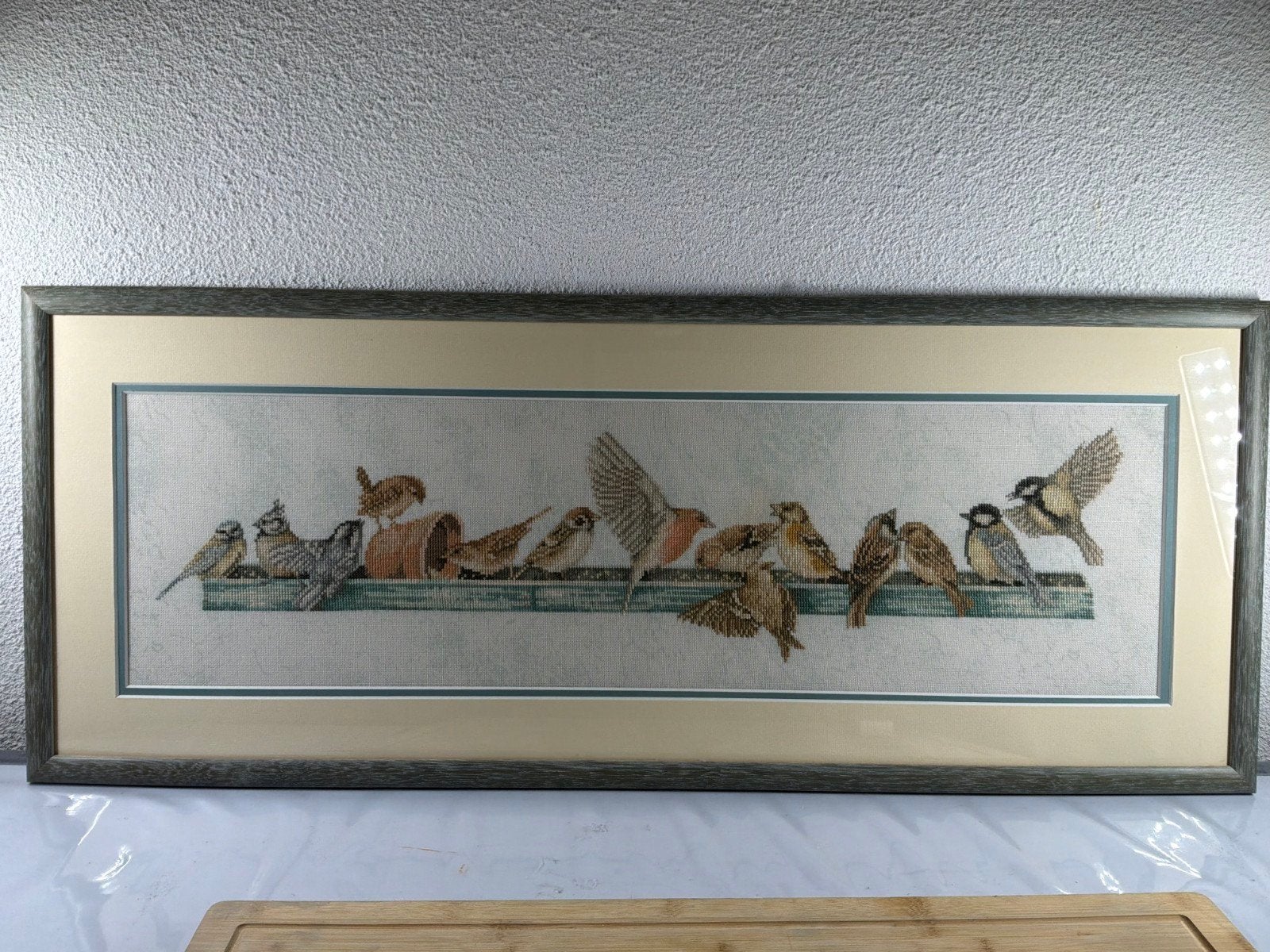 Geborduurde vogel landschappen, Ophalen