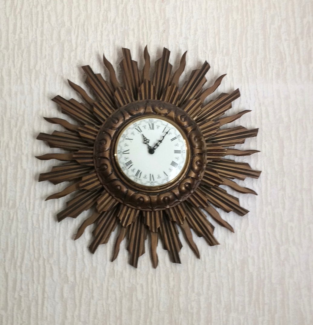 Goudkleurige houten zonneklok ., Huis en Inrichting, Ophalen, Goud, Wandklok, Vintage
