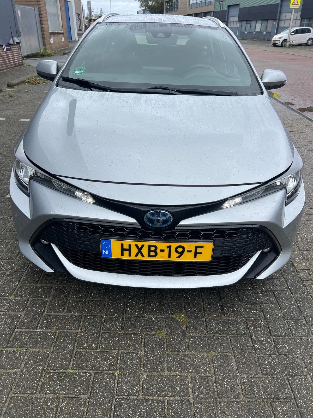 Toyota Corolla TS 1.8 Hybrid 122pk CVT 2022 Grijs, Auto's, 4 cilinders, Verwarmde buitenspiegels, 98 pk, Stationwagon