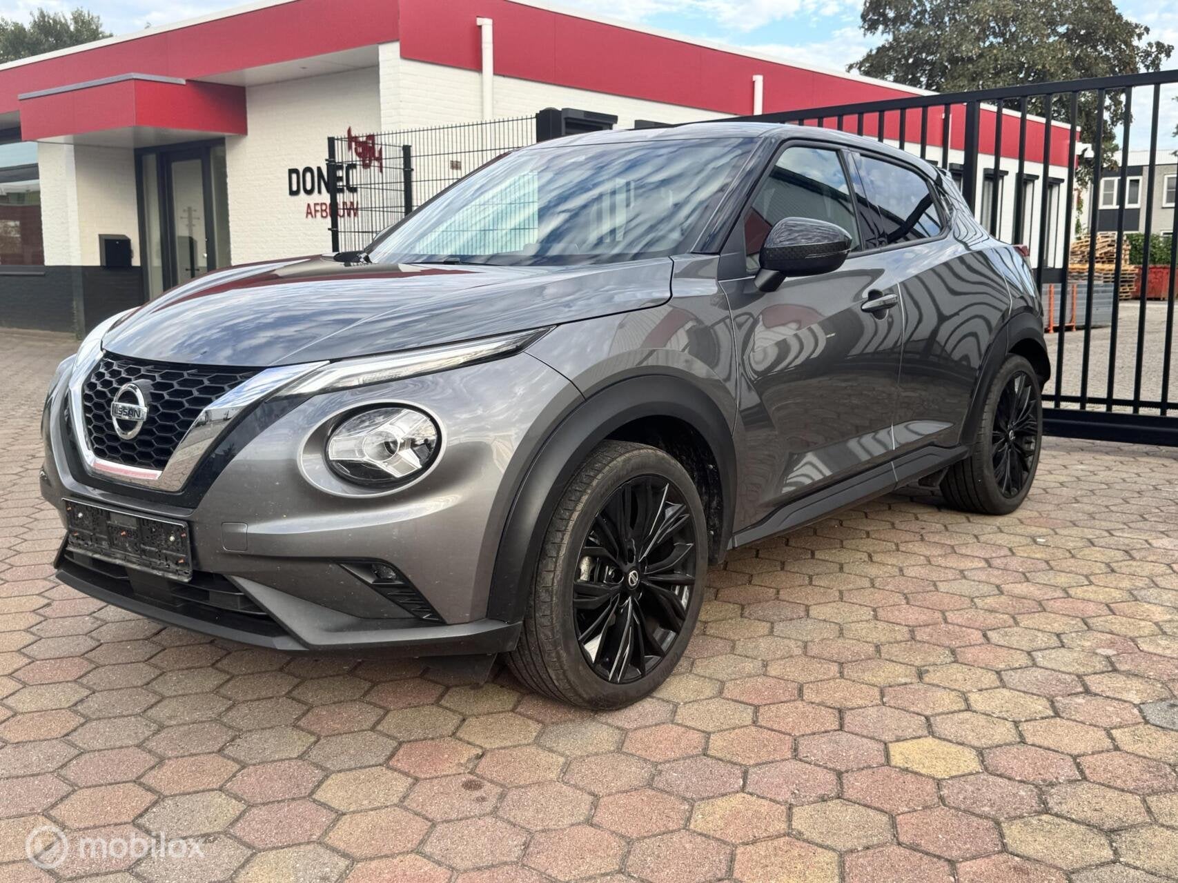 Nissan Juke 1.0 DIG-T Enigma Automaat NAVI CAMERA CLIMA 19'', Auto's, Dealer onderhouden, Gebruikt, Zwart, Bedrijf