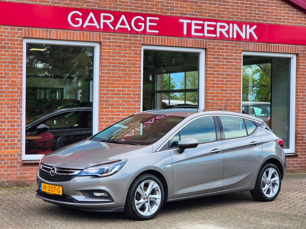Opel Astra 1.0 Innovation 105PK 5drs clima, cruise, navi, pd, Auto's, Opel, Gebruikt, Euro 6, Bruin, 23 km/l
