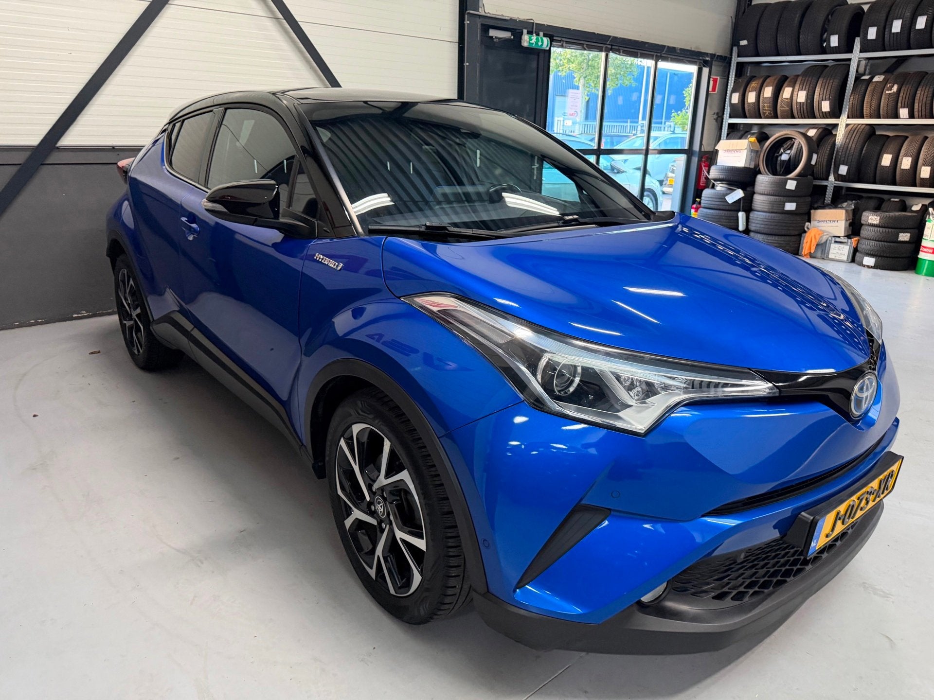 Toyota C-HR 1.8 Hybrid Bi-Tone|Camera|hybrid|Cruise|Navi|PDC, Auto's, 4 cilinders, Met garantie (alle), Blauw, 98 pk