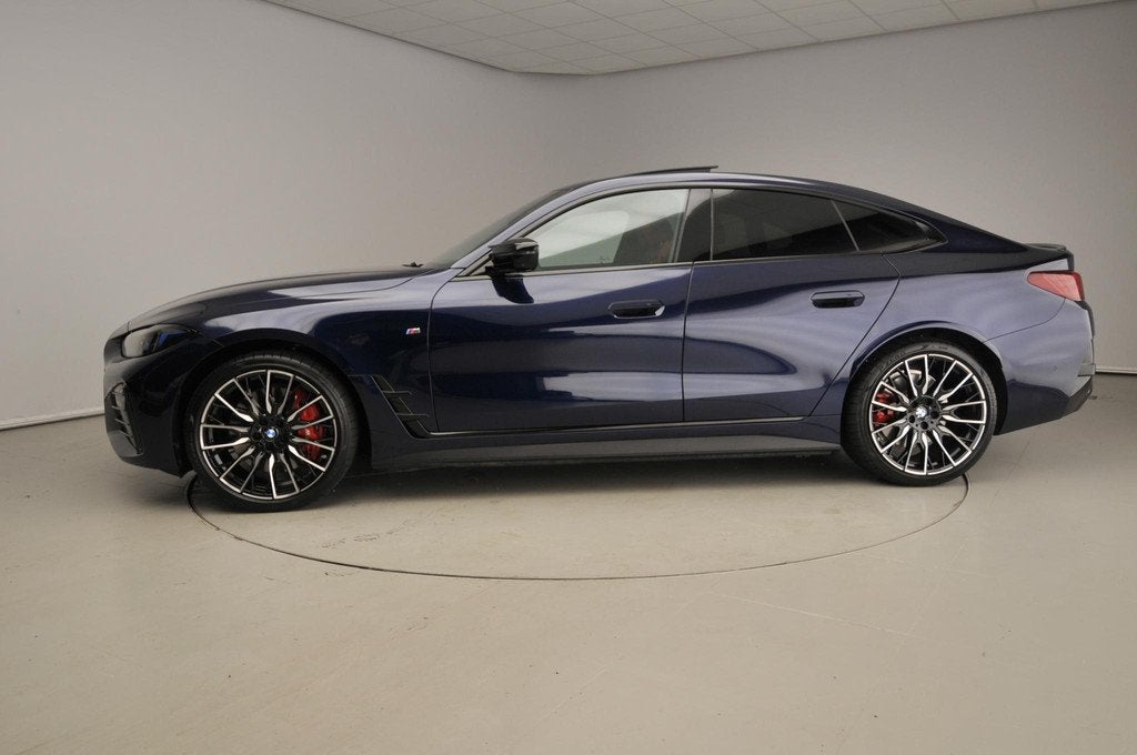 BMW i4 Grand Coupe M60 | M-Sportpakket | Leder | HUD | Activ, Auto's, BMW, Zwart, Met garantie (alle), Blauw, 601 pk