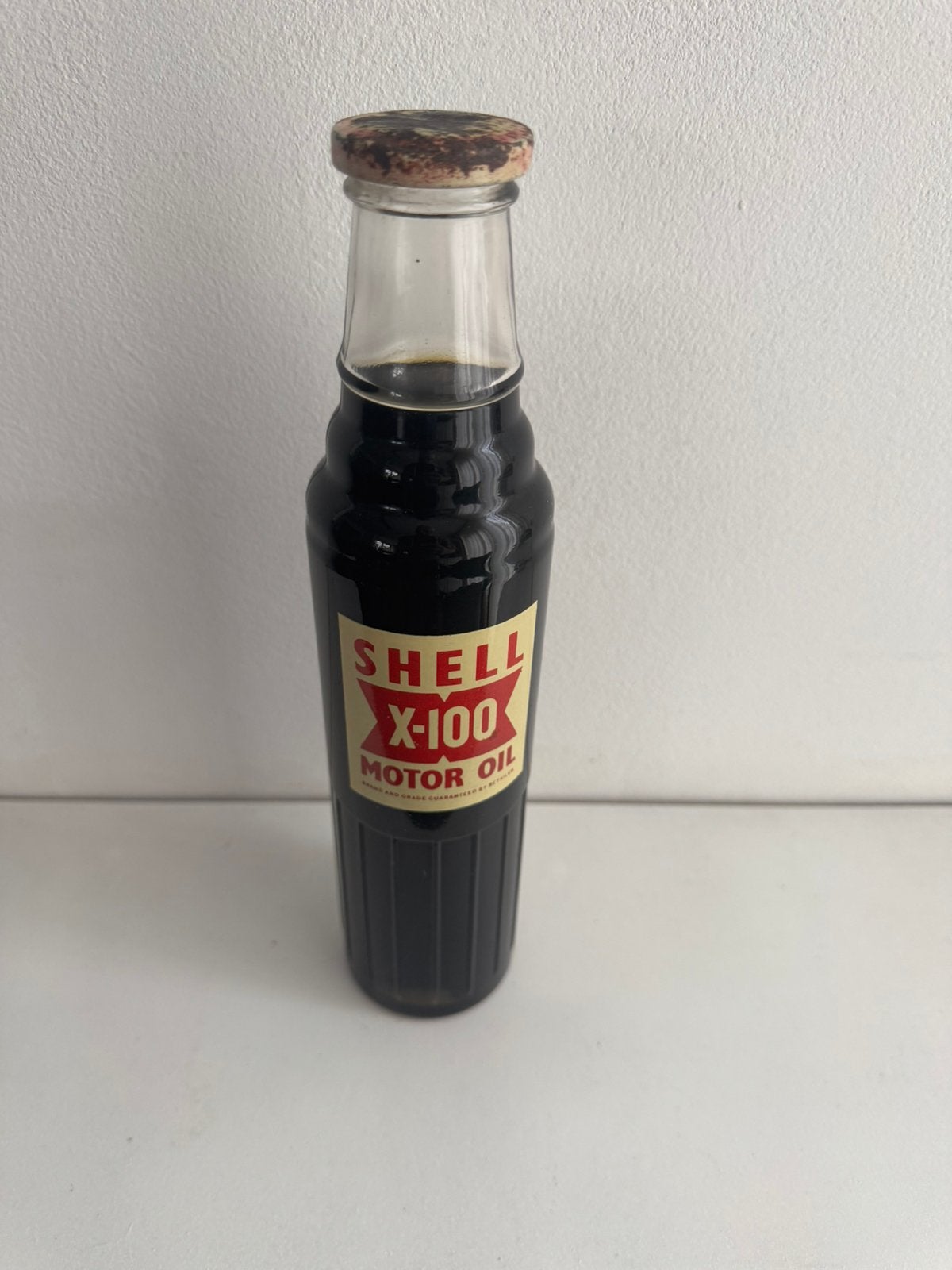 Oude Vintage Olie fles Shell X-100 vol met dop, Ophalen of Verzenden, Gebruikt, Verpakking