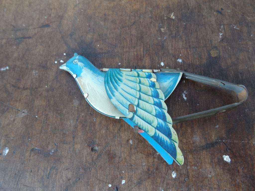 Oud blikken speelgoed vogel, Ophalen