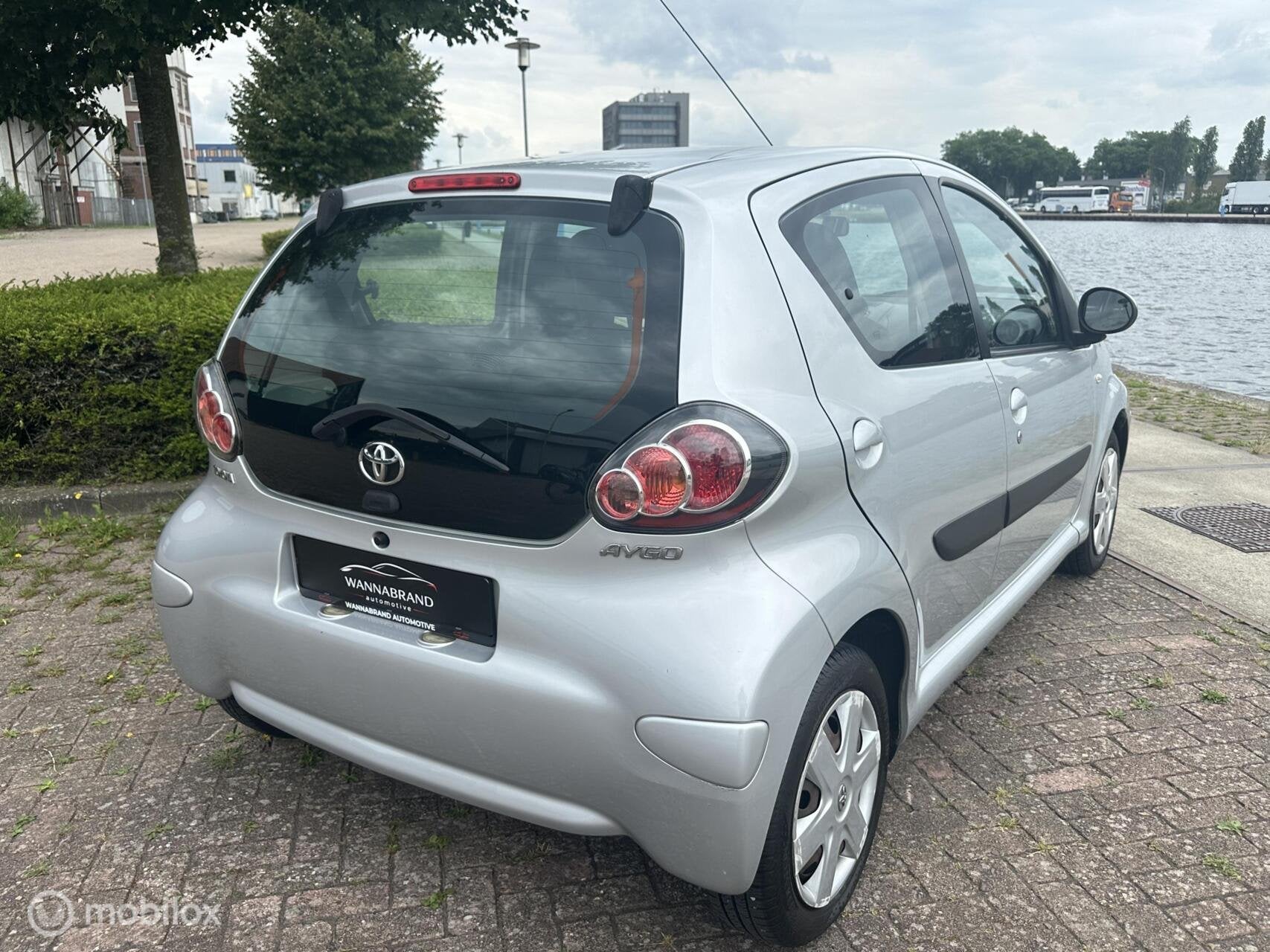 Toyota Aygo 1.0-12V Dynamic Navigator, Auto's, Voorwielaandrijving, Euro 5, Stof, Gebruikt