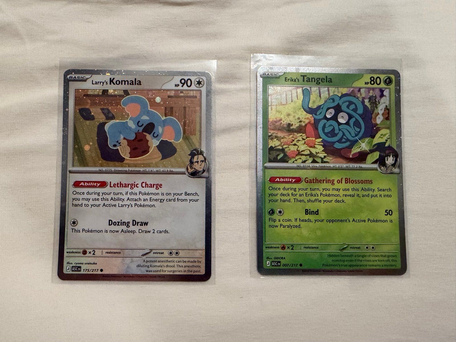 Larry's Komala & Erika's Tangela Cosmos Holo, Ophalen of Verzenden, Zo goed als nieuw, Meerdere kaarten, Foil