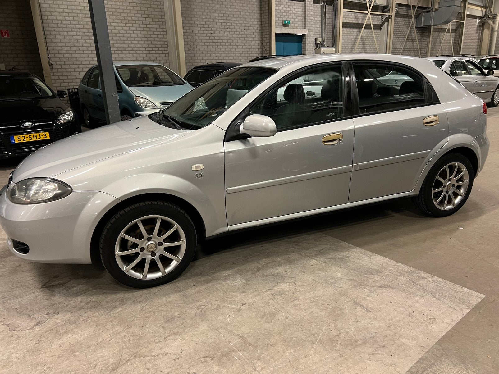 Daewoo Lacetti 1.6 HB 2004 Grijs km 224789, Auto's, Voorwielaandrijving, Lacetti, 4 cilinders, 610 kg