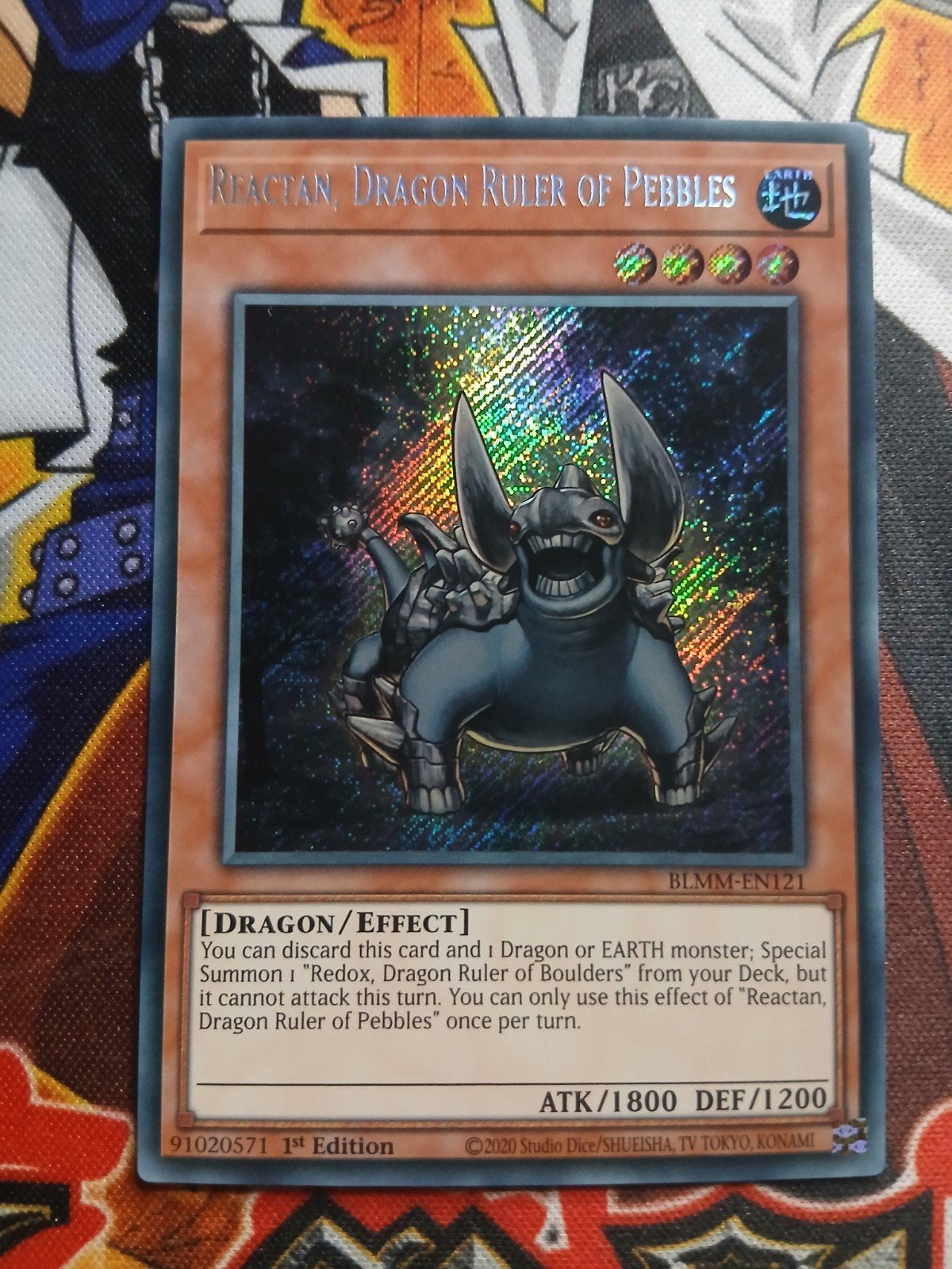 Reactan, Dragon Ruler of Pebbles - Secret Rare BLMM - YGO, Hobby en Vrije tijd, Ophalen of Verzenden, Zo goed als nieuw, Foil
