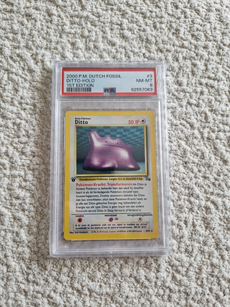PSA 8 Ditto Holo Dutch Fossil 1st Edition Pokémon, Ophalen of Verzenden, Zo goed als nieuw, Losse kaart, Foil