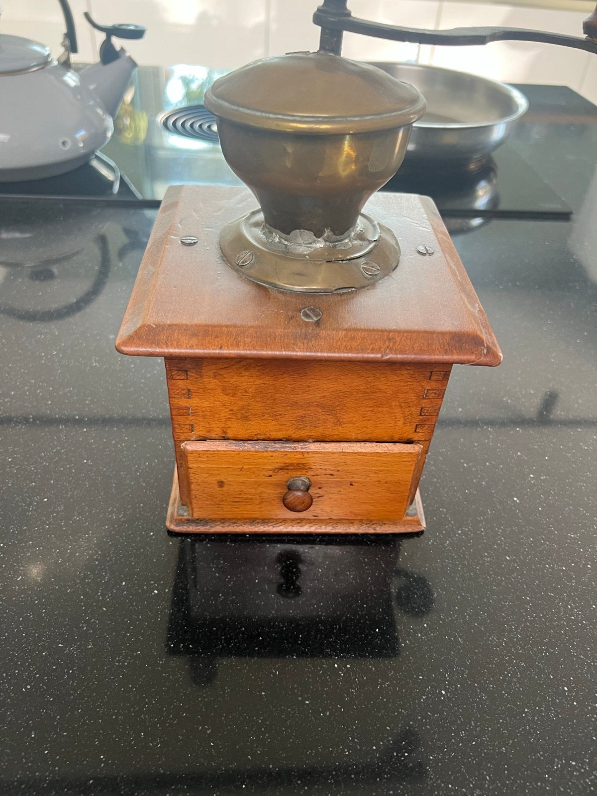 Antieke handmatige koffiemolen van hout en messing, Ophalen