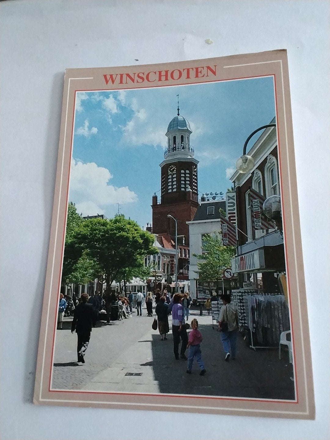 Ansichtkaart Winschoten met kerktoren en winkelstraat, Ophalen of Verzenden