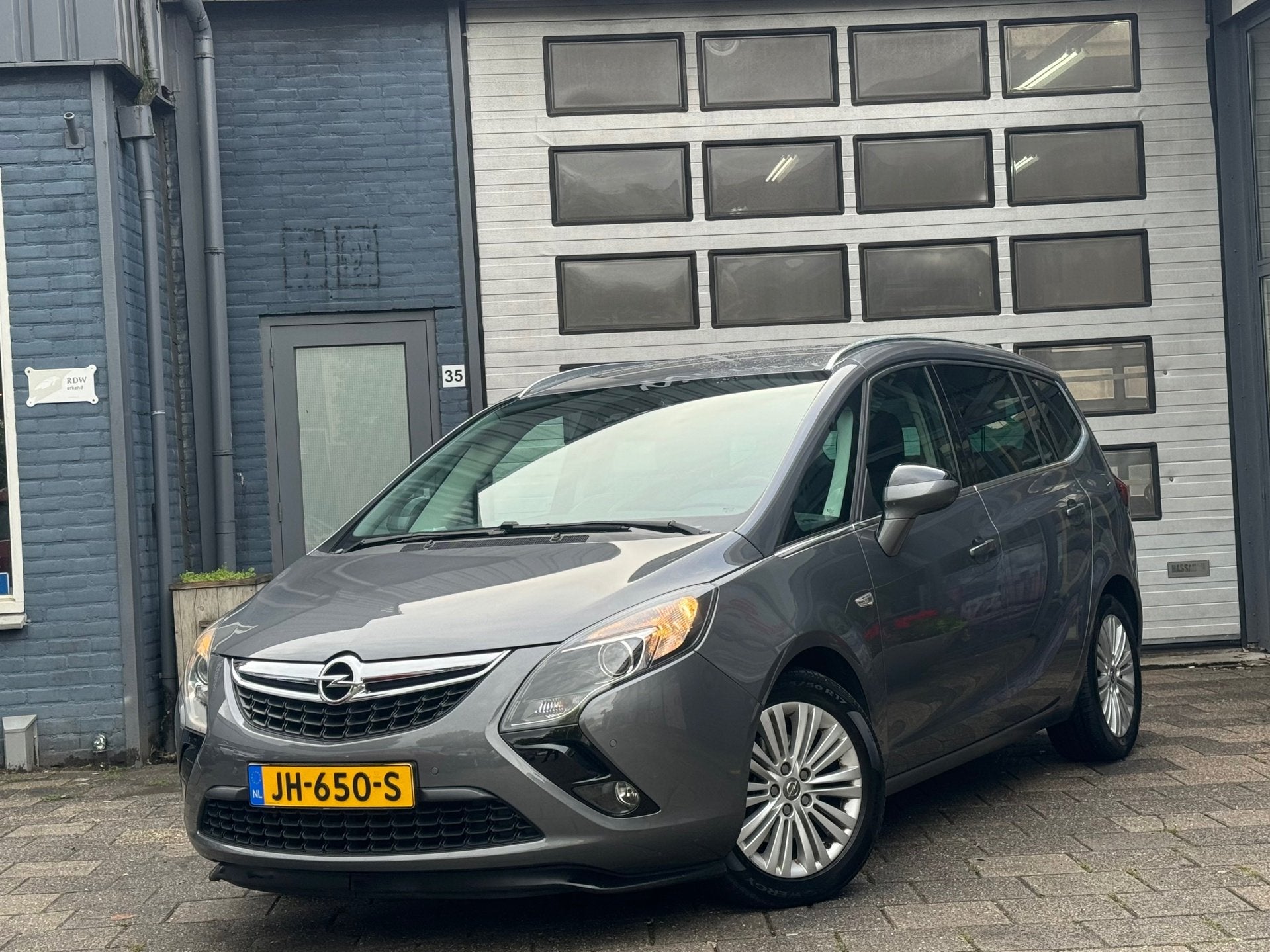 Opel Zafira Tourer 1.4 Edition 7P | Clima | Cruise | Navi |, Auto's, Dealer onderhouden, Gebruikt, Euro 6, 4 cilinders