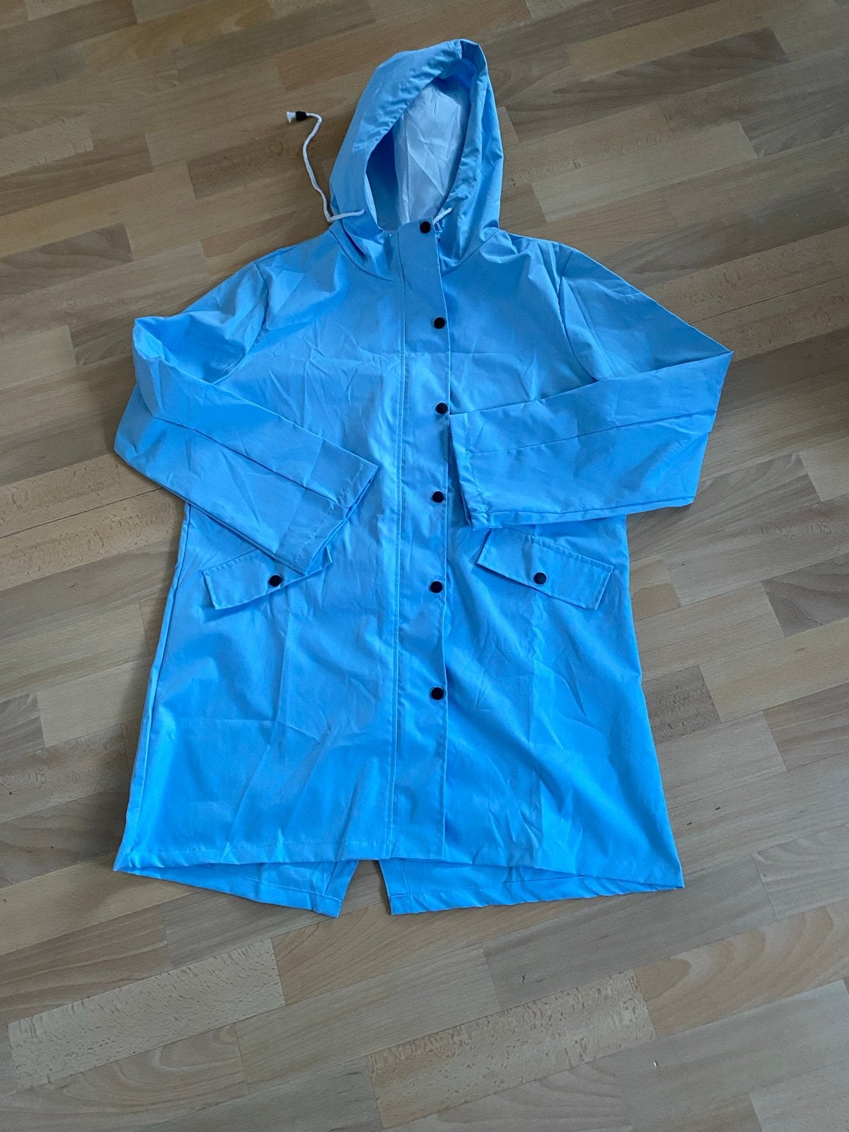 Lichtblauwe regenjas met capuchon nieuw 2XL, Ophalen of Verzenden, Nieuw, Maat 42/44 (L), Blauw