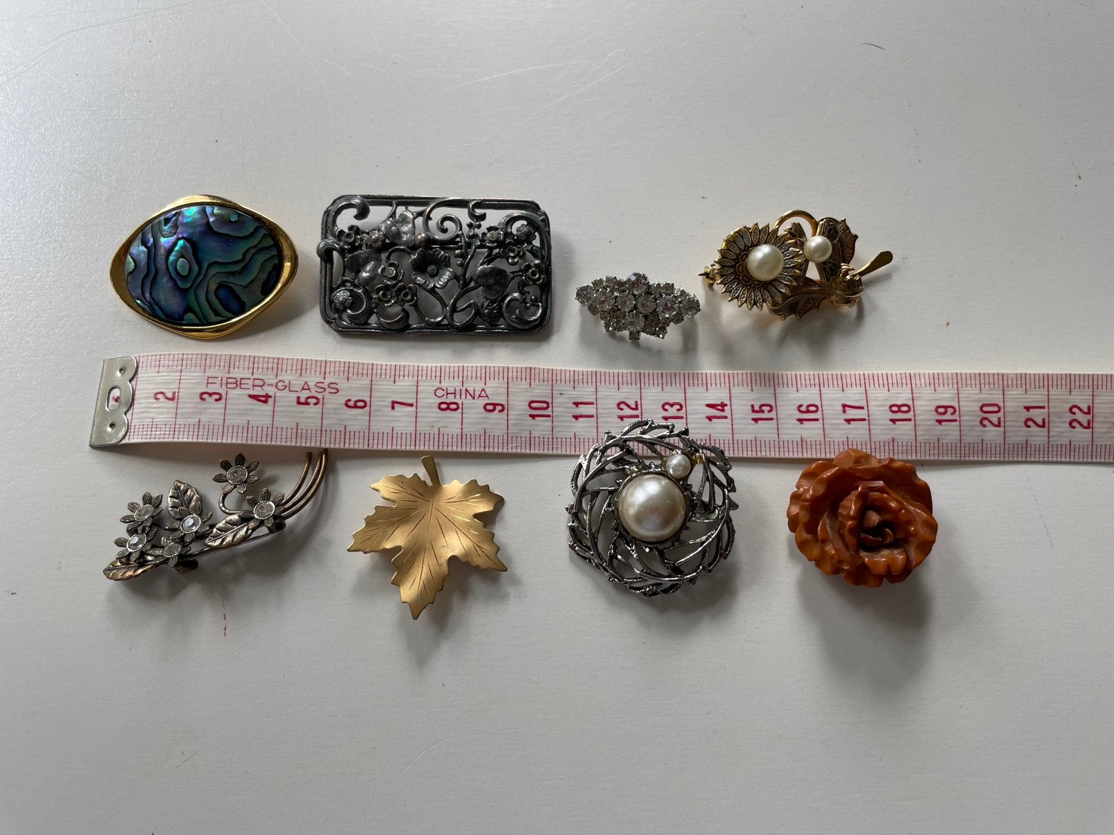 Lot van 8 broches ( in Hilversum ), Ophalen of Verzenden, Gebruikt, Overige kleuren, Overige materialen