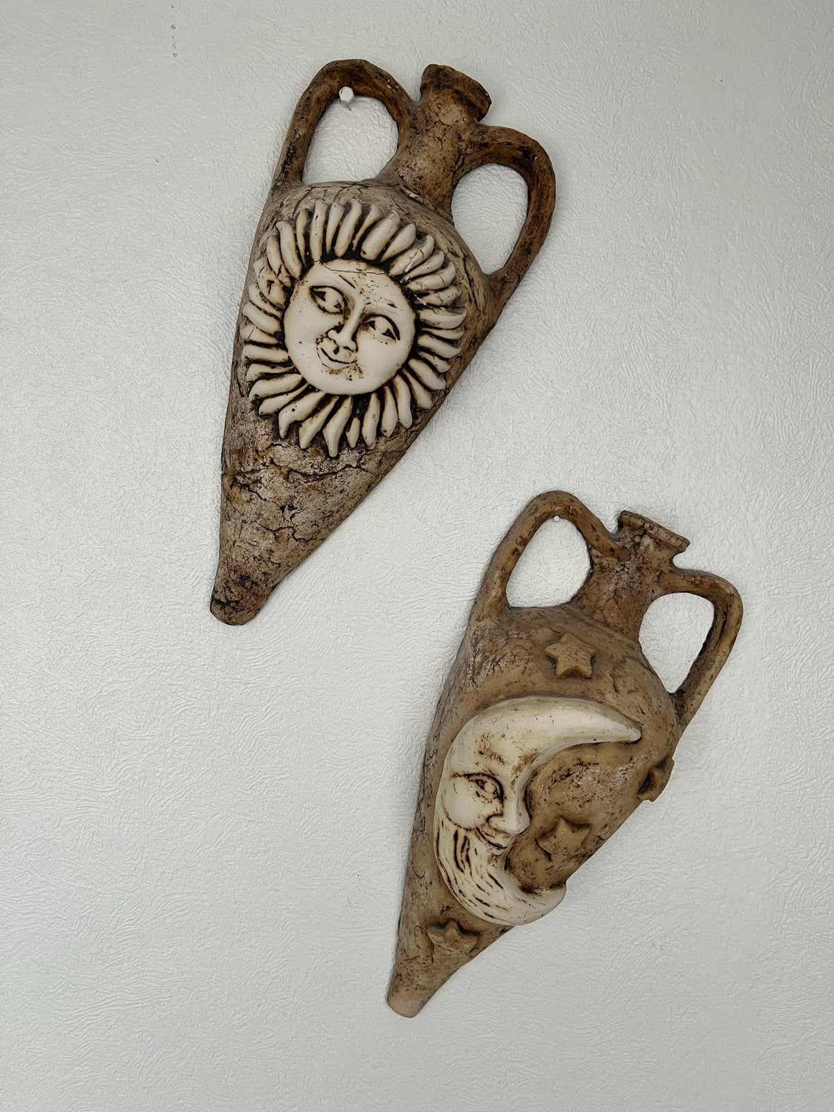 Aardewerk wanddecoratie zon en maan, Ophalen