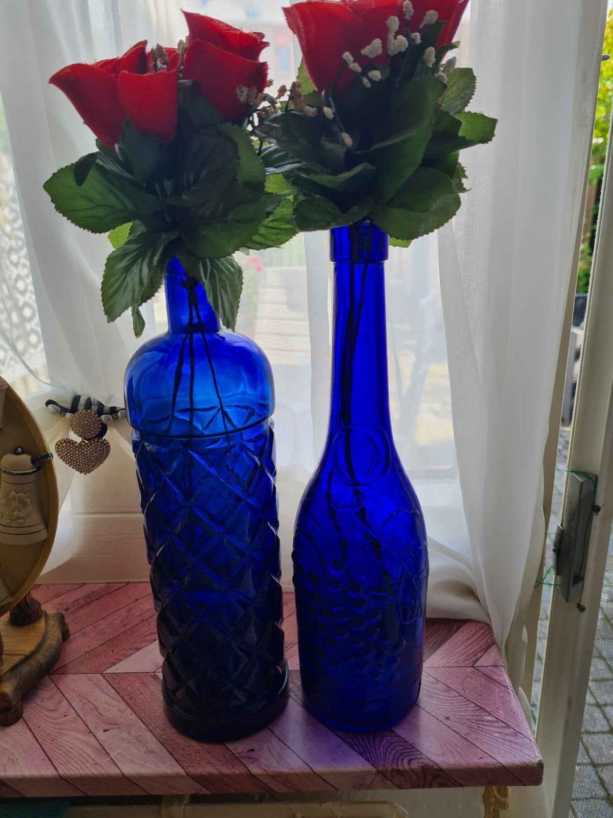 Twee kobaltblauwe flessen met kunstbloemen, Ophalen