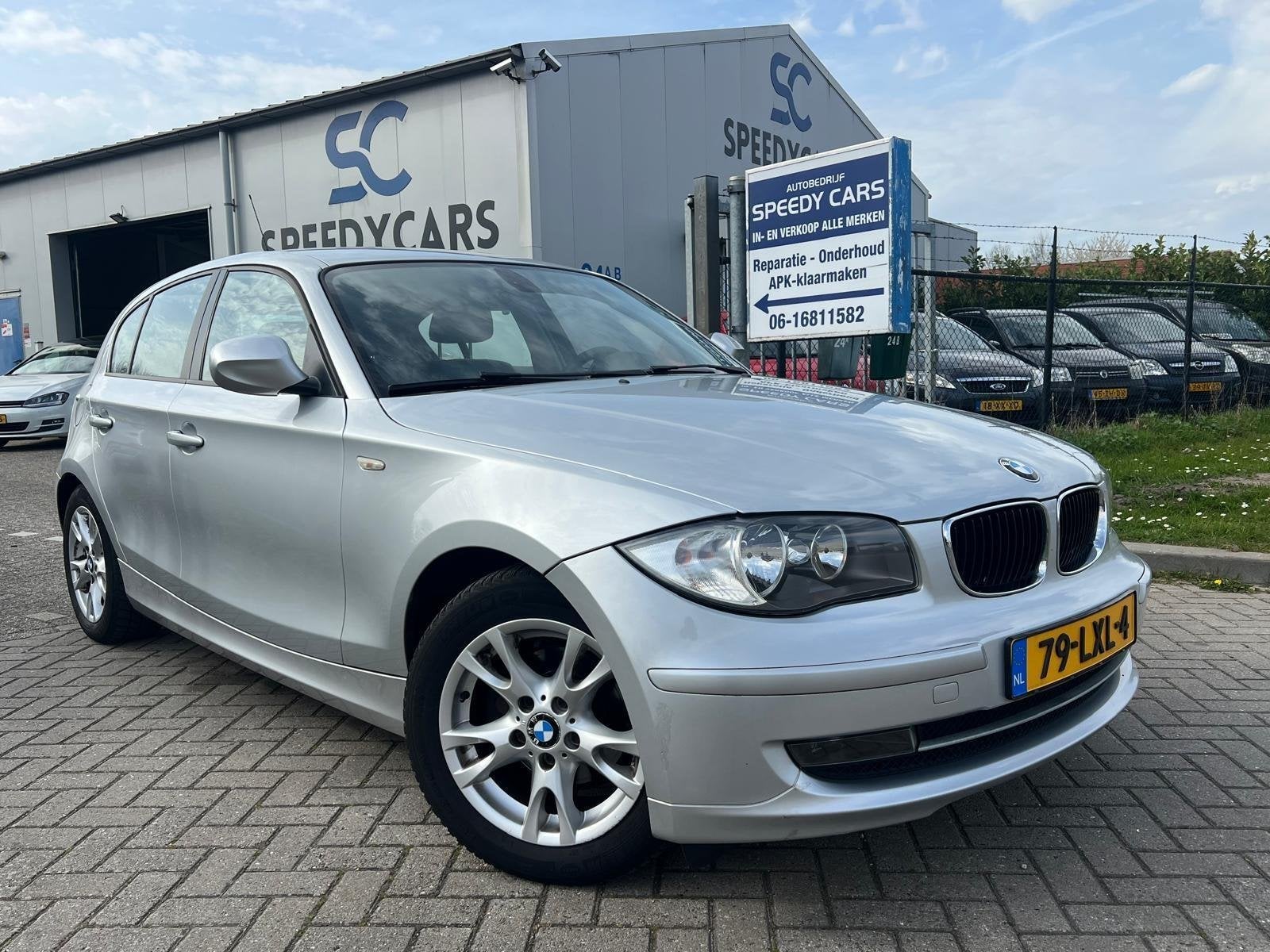 BMW 1-serie 116i High Executive 5DRS 2010 Leer Clima, Auto's, 1-Serie, Euro 5, Achterwielaandrijving, Zwart