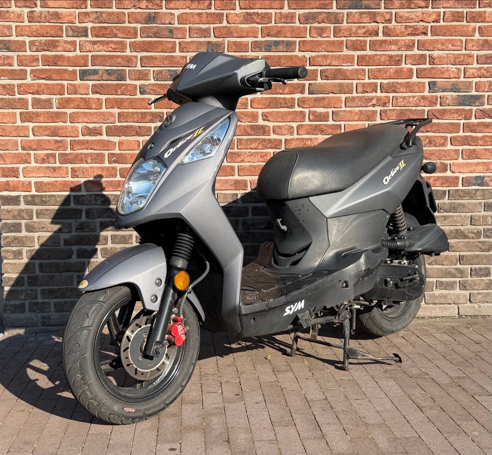 SYM Orbit 2 Scooter | Matgrijs | Gecertificeerd kettingslot, Ophalen, Gebruikt, Maximaal 45 km/u, Benzine