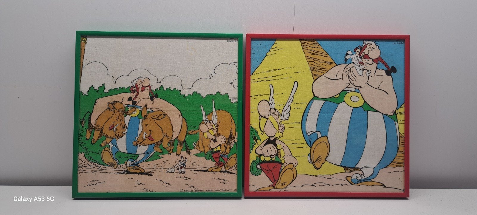 2x Asterix en Obelix Prenten - Da Colombo - 24x24 cm, Gebruikt, Met lijst, A4 of kleiner, Vierkant