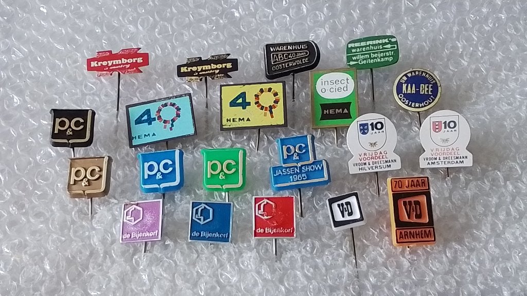 20 verschillende speldjes warenhuizen, Verzamelen, Speldjes, Pins en Buttons, Ophalen of Verzenden, Zo goed als nieuw, Overige onderwerpen