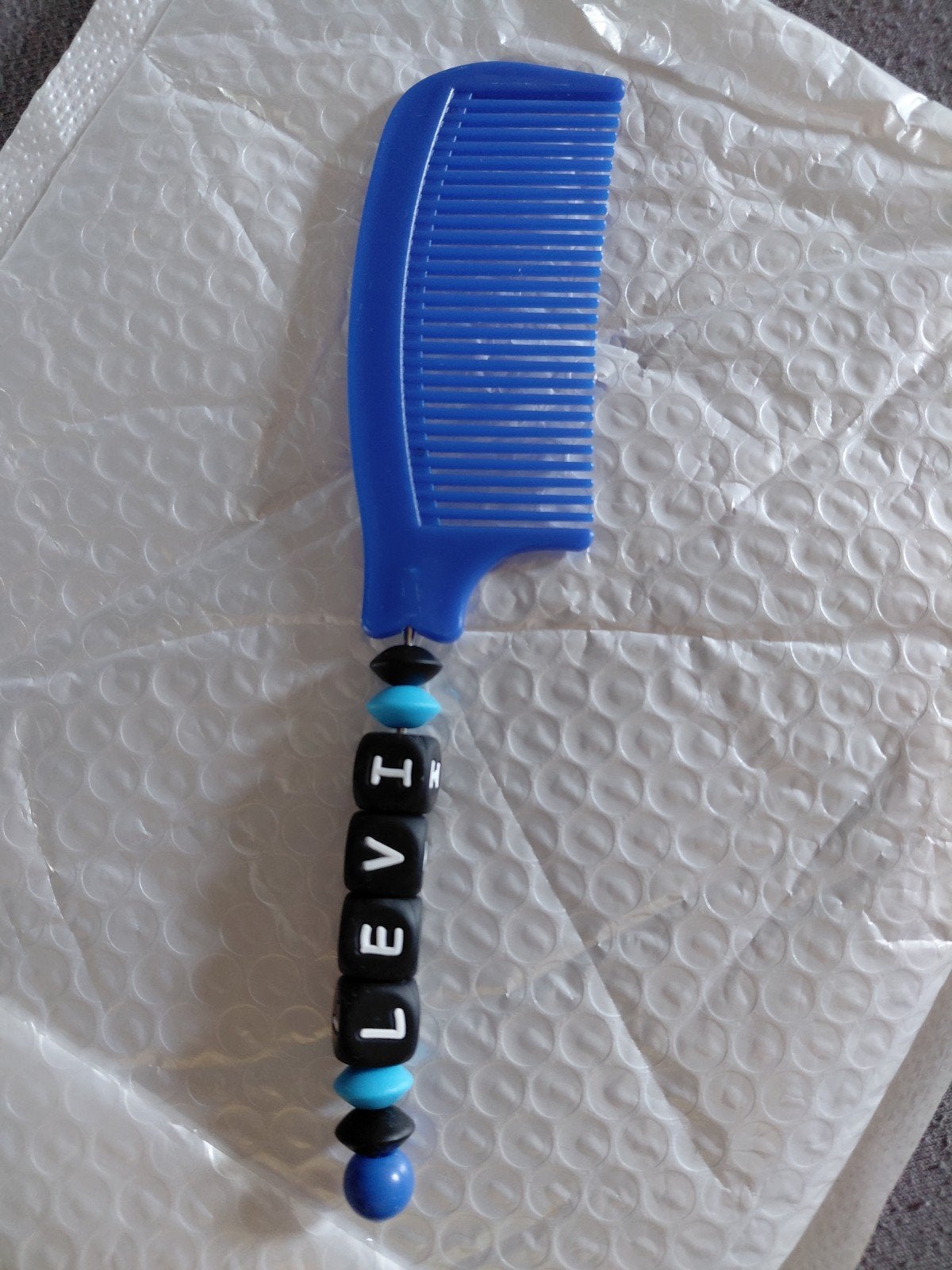 Blauwe kam met naam 'LEVI. Nieuw, Sieraden, Tassen en Uiterlijk, Uiterlijk | Haarverzorging, Ophalen of Verzenden, Nieuw, Kam of Borstel