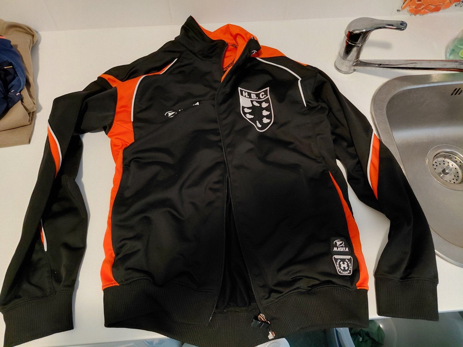 HBC Voetbal Jasje - Zwart/Oranje Trainingsjack, Ophalen
