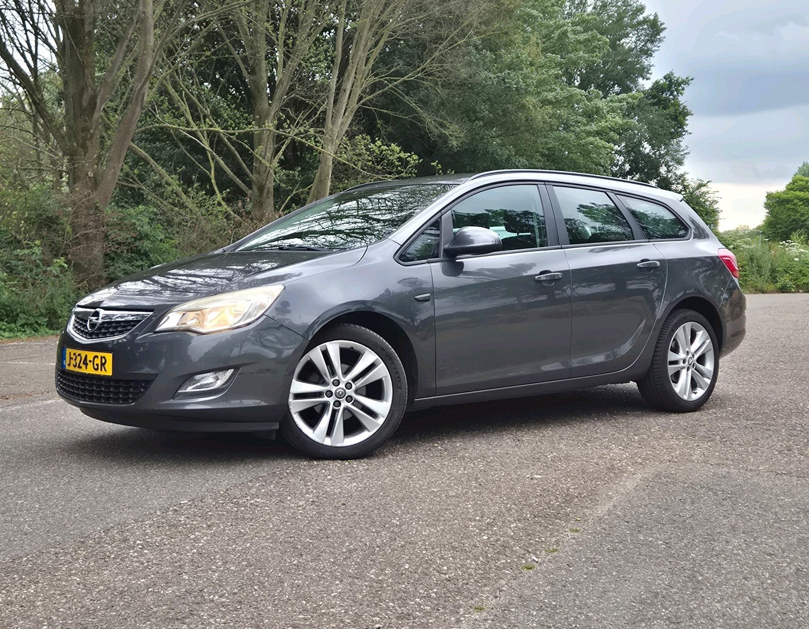 Opel Astra 1.4 Turbo 103KW 5D AUT 2012 Grijs, Auto's, Voorwielaandrijving, Euro 5, Stof, Zwart