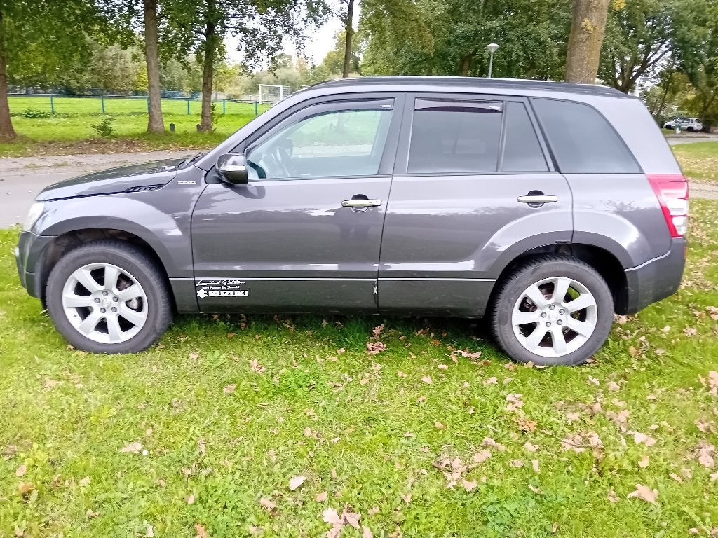 Suzuki Grand Vitara 2.4L 4x4 Benzine 2010, Auto's, Verwarmde buitenspiegels, Zwart, 4 cilinders, Grand Vitara