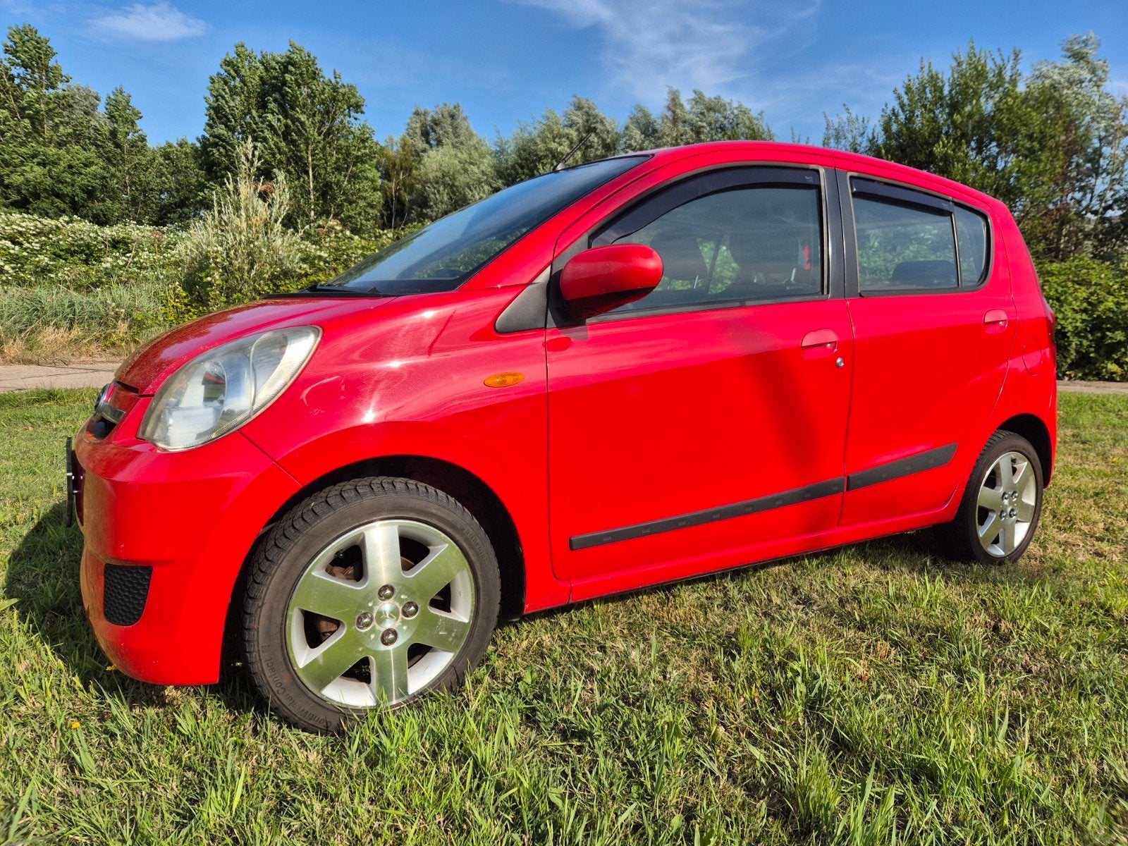 Daihatsu Cuore 1.0 5D 2007 Rood premium, Auto's, Daihatsu, Voorwielaandrijving, Stof, 600 kg, Zwart