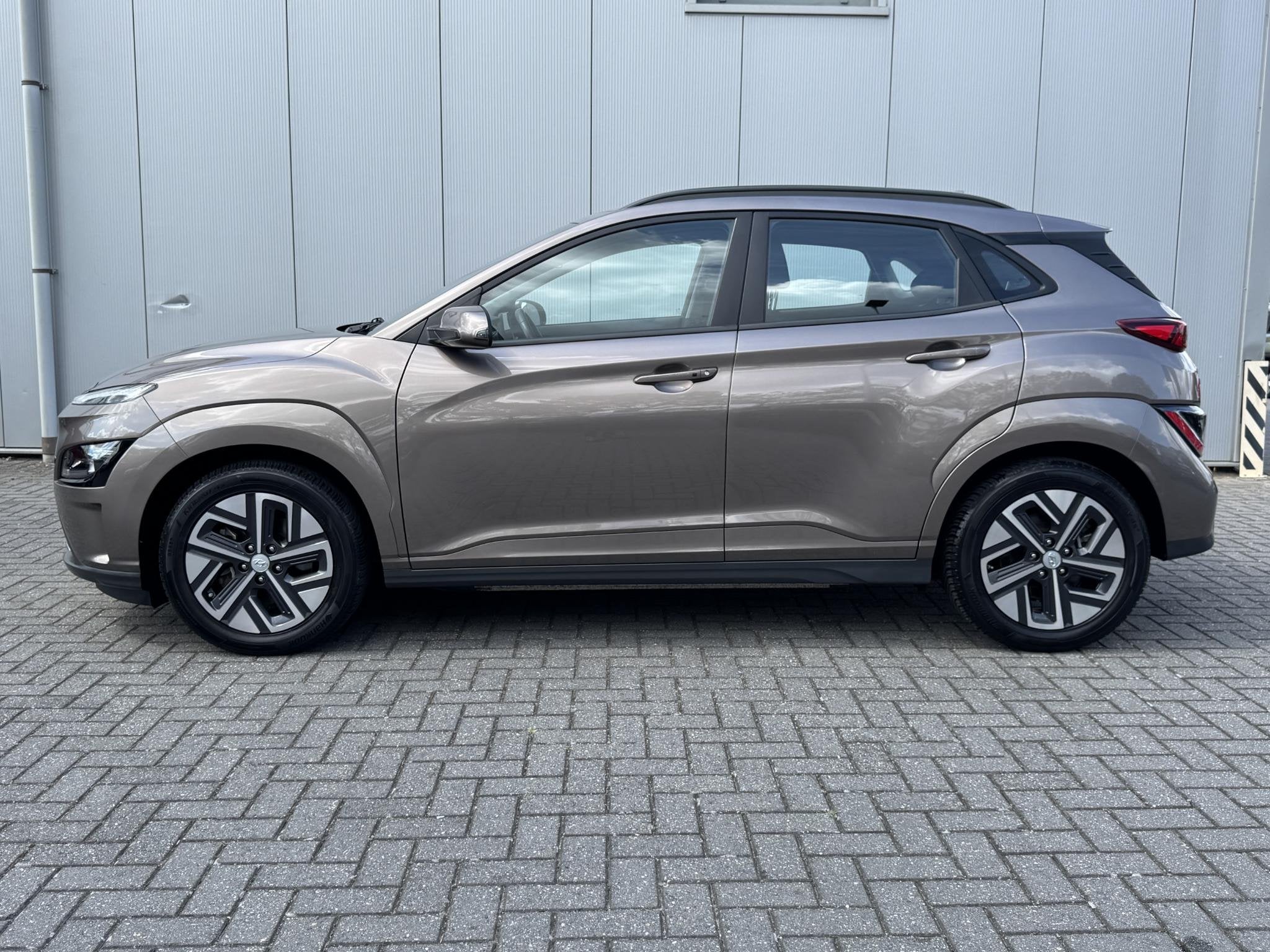 Hyundai Kona EV Comfort 64 kWh / Warmtepomp / SOH 100% / Nav, Stof, Gebruikt, Bruin, Origineel Nederlands